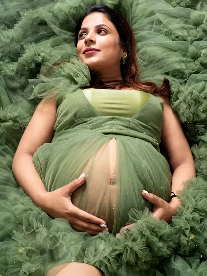 A quiet moment of connection with your baby. I designed this shot to feel like you are floating in a sea of dreams, surrounded by the soft ruffles of this gorgeous green gown from my collection.