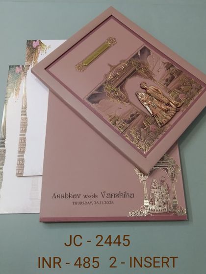 This dusty rose invitation features a framed 3D sculpture of a wedding ceremony. The unique design and luxurious finish make it a standout choice for your special day.