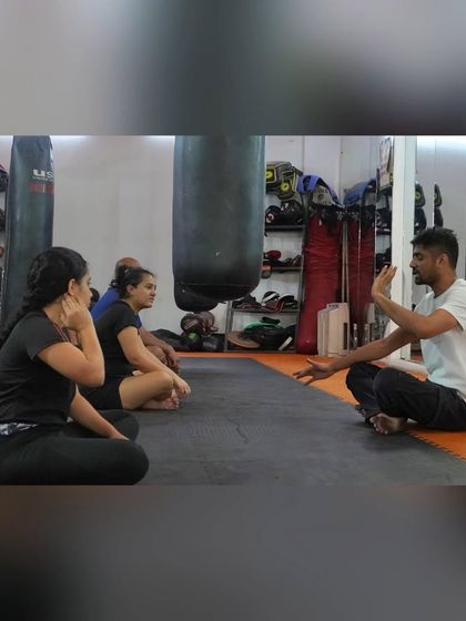 A coach leads the group in breathing exercises during our wellness event. It's the perfect way to unwind and recharge.