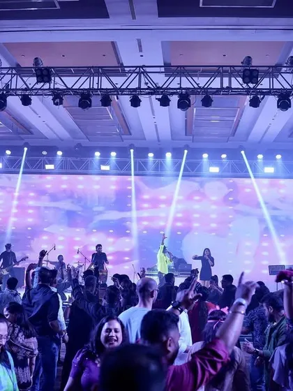 A wide shot of the massive setup and packed dance floor at a corporate event. We ensure a grand production with incredible sound and lighting to match the energy.