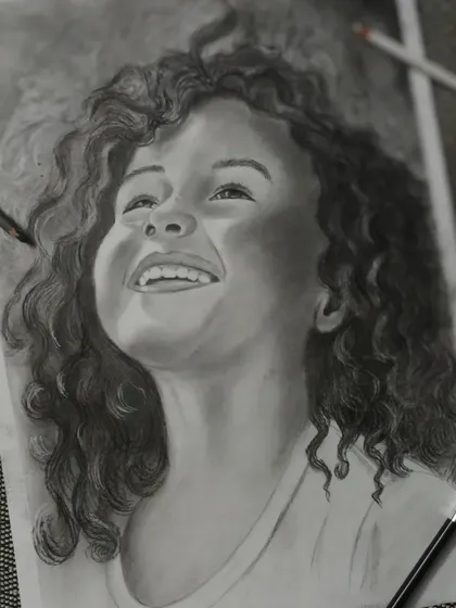 I created this charcoal portrait to capture the pure happiness in a child's expression. In my classes, I teach how to use light and shadow with charcoal to create this kind of depth and emotion, turning a simple sketch into a powerful piece of art.