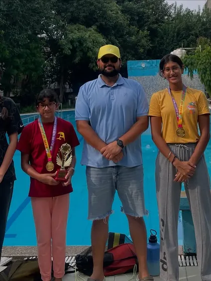 My swimmers showcasing their 17-medal haul from India's biggest invitational swim meet. We also secured two 'Best Swimmer' trophies, proving our strength in a large, competitive field.