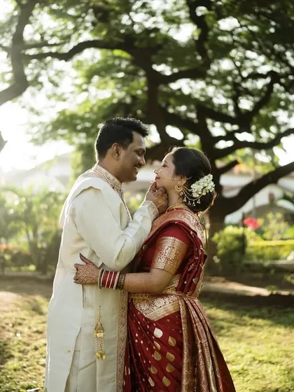A tender moment under a magnificent tree. The golden sunlight adds a magical quality to this romantic portrait, emphasizing the beauty of both the couple and the setting.