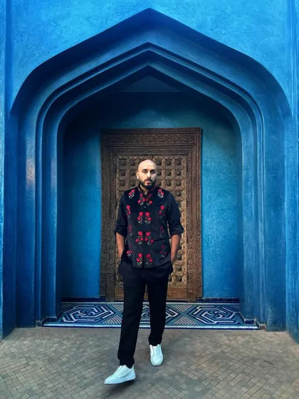 Full-length shot in the famous blue alley in Morocco. The vibrant colors of our destination weddings are a huge part of the experience.