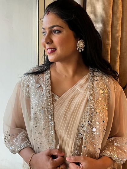 A modern yet traditional party look. The client is wearing a beautiful saree with a mirror-work jacket.