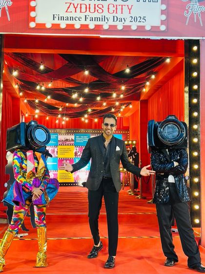 Posing with themed performers at the Zydus Finance Family Day. I work closely with event planners to ensure every element, including my own presence, aligns perfectly with the corporate event's theme and brand.