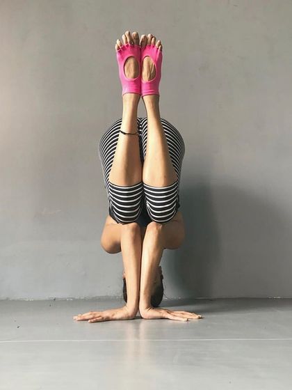 This forearm stand variation of a wide-legged forward bend is an intense inversion that deeply stretches the hamstrings. It's a pose that requires both strength and flexibility.