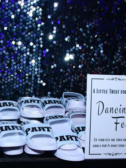A little treat for tired dancing feet! We set up a station with comfortable slippers for guests to change into, ensuring they could stay on the dance floor all night long without a worry.