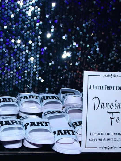 A little treat for tired dancing feet! We set up a station with comfortable slippers for guests to change into, ensuring they could stay on the dance floor all night long without a worry.