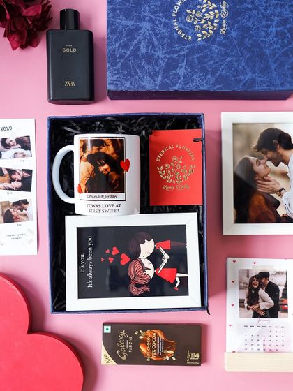 The 'Sweetheart's Delight' hamper for him, featuring a personalized mug, framed photos, a custom calendar, perfume, and chocolate.