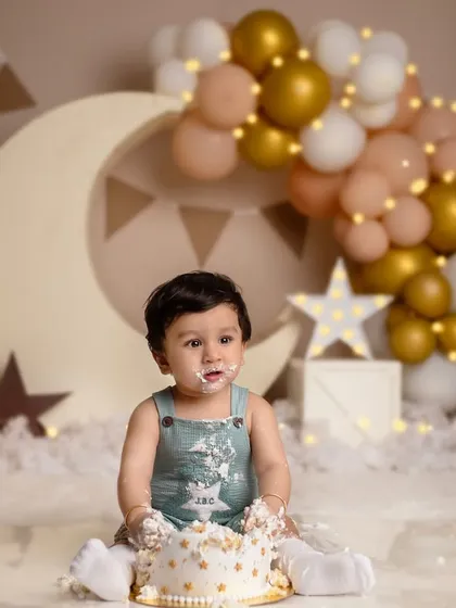 Style, charm, and a little bit of mischief. This handsome little man is enjoying his cake during his moon and stars-themed shoot.