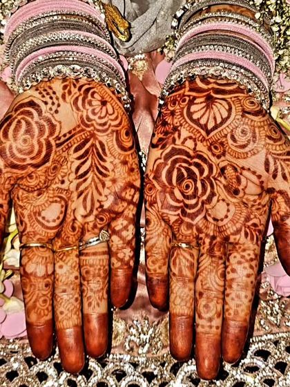The palms of the 'Baat Pakki' mehendi, showing the rich stain and floral design.