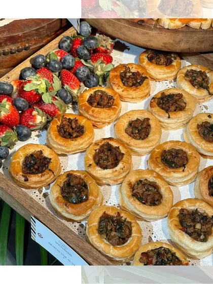 Our savory mushroom tarts, served on a wooden platter alongside fresh strawberries and blueberries. The combination of earthy, savory, and sweet flavors is simply delightful.
