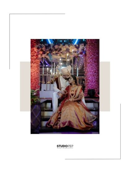 A romantic, softly lit portrait of the couple seated on a staircase, the decor and lighting creating a dreamy atmosphere.