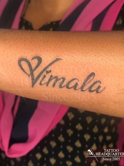 The name "Vimala" in a clean, cursive script on the forearm.