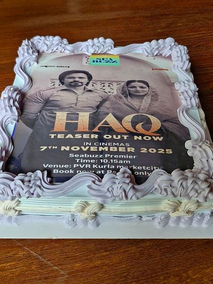 Another angle of our custom cake for the 'HAQ' movie premiere, showing the detailed piping work that frames the edible movie poster.