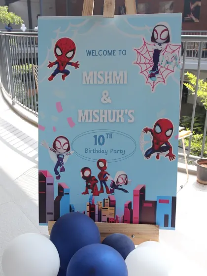 A welcome sign for a joint 10th birthday party with a Spidey and His Amazing Friends theme. The sign features various spider-characters, setting the stage for an action-packed celebration.