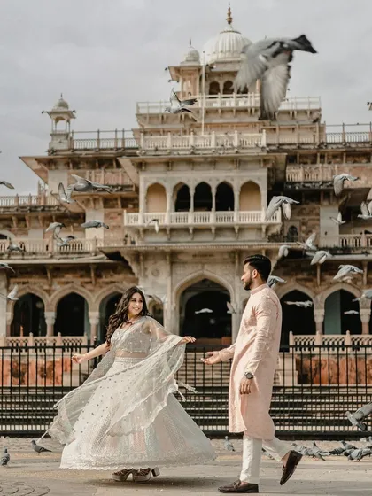 A moment of magic at Jaipur's Albert Hall Museum. The flock of pigeons taking flight adds a dynamic, unscripted layer to this royal portrait, blending classic architecture with spontaneous joy.