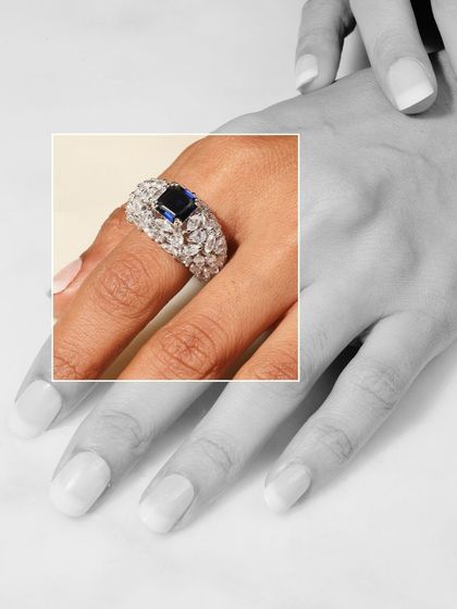 A creative shot of the Blue Sapphire Cocktail Ring, with the focus on the ring against a black and white background, making the blue stone the undeniable hero.