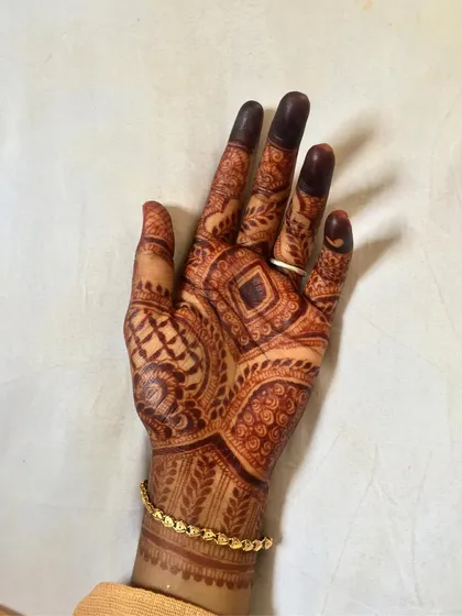 Another view of this geometric design, showing the consistent dark stain across the entire palm and fingers.