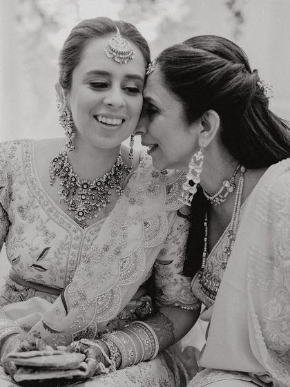 A black and white photo that captures the pure emotion between a bride and her mother. Glam is just the surface; the real glow comes from these beautiful bonds.
