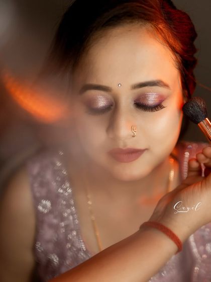 An artistic shot of the makeup application for Raksha's reception. This shows the careful blending of eyeshadow to create a soft, shimmery look.