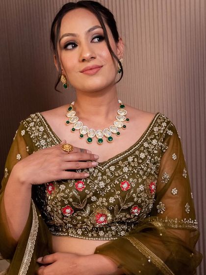 This olive green blouse with delicate red and pink floral embroidery is perfect for a mehendi look. We offer a variety of blouses that can be mixed and matched or rented as part of a set.