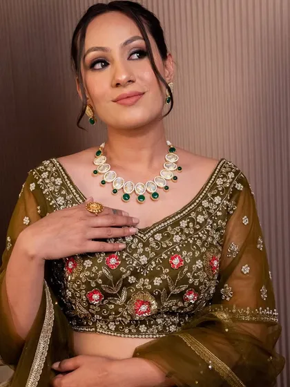 This olive green blouse with delicate red and pink floral embroidery is perfect for a mehendi look. We offer a variety of blouses that can be mixed and matched or rented as part of a set.