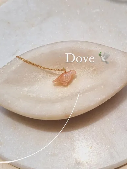 A final look at the peach moonstone 'dóve' pendant, a symbol of peace and abundance.