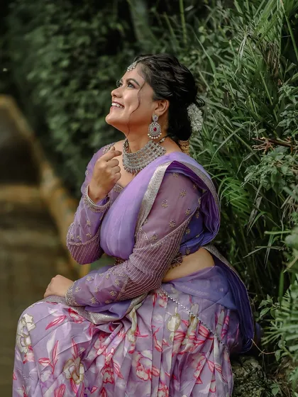 A joyful shot of the model, giving a different angle of the modern AD choker set and how it complements a contemporary saree look.