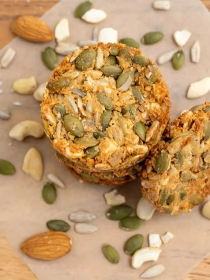 Our multi-seed cookies on a rustic wooden board. We believe that healthy food should be beautiful, and these cookies are a testament to that philosophy.