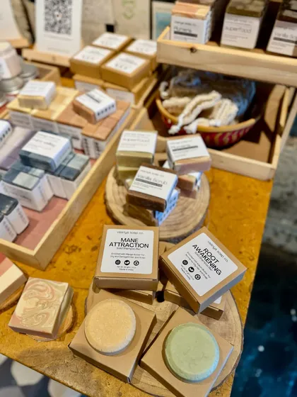 Weekend views from our pop-up at Greenr Cafe. Our solid shampoo bars are displayed on rustic wooden slices.