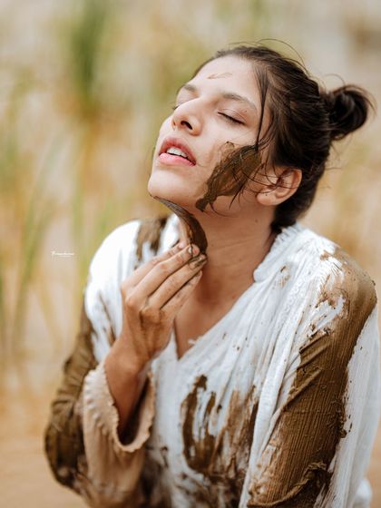 This close-up captures a serene and almost meditative expression, contrasting with the raw, earthy setting.