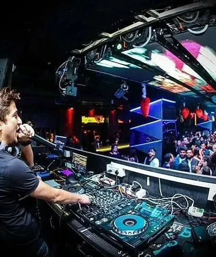 On the mic, interacting with the Saturday night crowd at Privee'. A DJ's job is to be the life of the party.