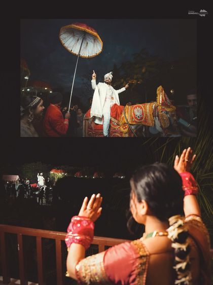 A creative perspective of the baraat. The bride watches from a balcony as the groom makes his grand entrance on a horse, a beautiful storytelling shot that connects their two journeys.