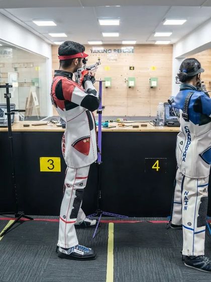 Shooters in formation during a practice session, each one focused on their target.