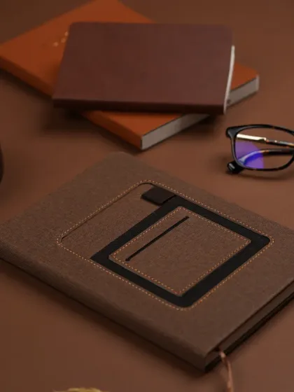 For corporate and professional products like this journal from Writenery, we create clean, sophisticated flat lays. The composition uses a rich, monochrome palette and organized props to convey a sense of focus and productivity.