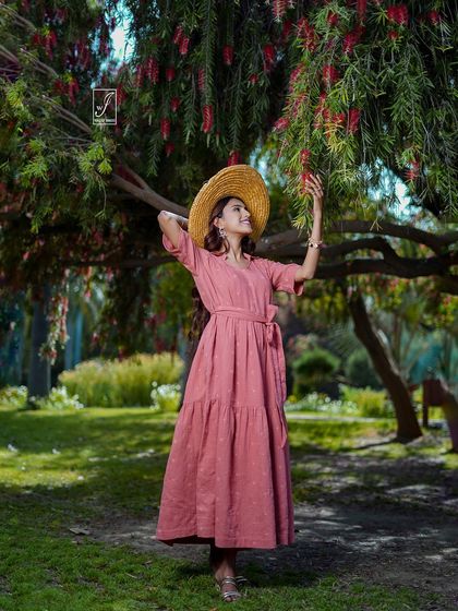An interactive pose where the model reaches for the flowers, creating a natural and engaging moment that feels unscripted.