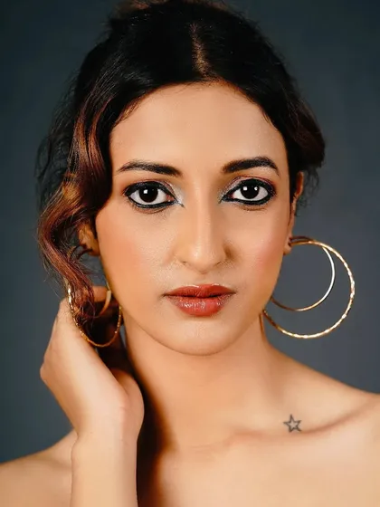 A creative take on eyeliner, with a pop of silver in the inner corner to brighten and add a touch of the unexpected. Paired with a kohl-rimmed water line, it's a modern twist on a classic look.