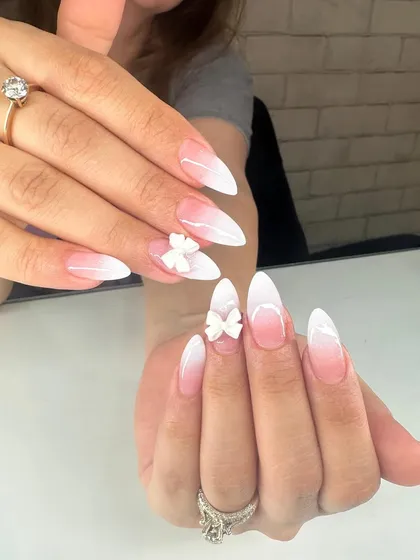 A perfect choice for a special occasion, this design features a soft white ombré fade on stiletto nails. I added delicate, sculpted 3D white bows as a charming and elegant accent.