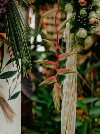 A close-up of the tropical foliage and flowers used in the decor, adding a touch of natural beauty to the event.