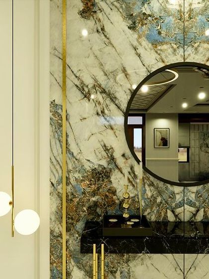 A close-up of the console area, with the dramatic marble veining, circular mirror, and minimalist decorative vases.
