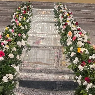 A close-up of floral decorations on a mirrored staircase, showing my attention to detail in every part of the venue.