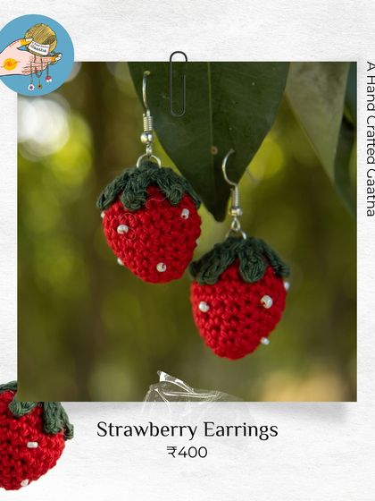 A close-up of my crochet strawberry earrings. I add tiny white beads for the seeds to make them look extra juicy and cute.