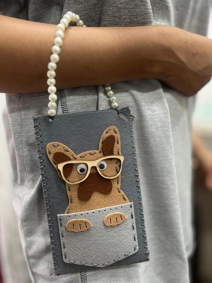 How adorable is this? One of our talented summer camp students crafted this dog-themed felt pouch, complete with hand-stitching and a cute pearl handle.