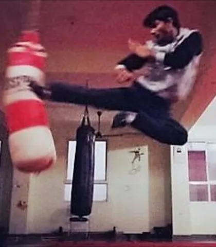 Unleashing explosive power. This flying kick on the heavy bag demonstrates the advanced striking techniques and athleticism we develop in our students.