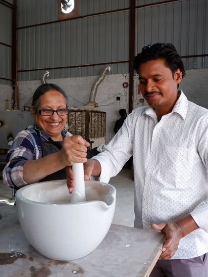 Teamwork makes the dream work! I'm helping a student grind materials for our Raku glaze. It's a physical process, but so rewarding.
