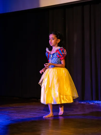 Our Snow White, standing gracefully on stage. We work on posture and stance to help children develop a confident and poised stage presence.