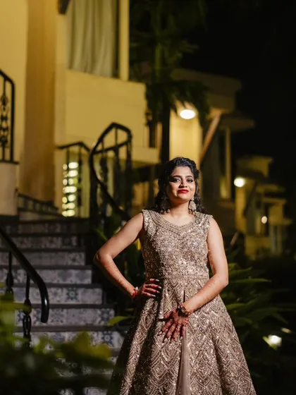 A series of photos from a Sangeet night in Goa. This look features a classic combination of smokey eyes and red lips, paired with a side-swept curly hairstyle, creating a glamorous and festive vibe.