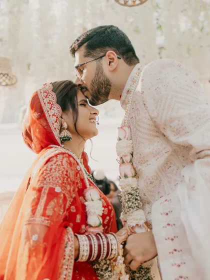 An intimate and tender moment between the bride and groom during their Gujarati wedding ceremony.